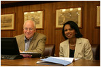 Vice President Dick Cheney and Secretary of State Condoleezza Rice smile while participating in a video teleconference from Camp David, Md. with President Bush and Iraqi Prime Minister Nouri al-Maliki in Baghdad, Tuesday, June 13, 2006.