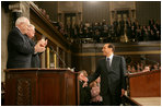 Italian Prime Minister Silvio Berlusconi smiles at Vice President Dick Cheney and House Speaker J. Dennis Hastert, as he gestures in response to a warm welcome given by members of a joint session of Congress, Wednesday, March 1, 2006.