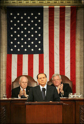 Vice President Dick Cheney and House Speaker J. Dennis Hastert applaud Italian Prime Minister Silvio Berlusconi during an address to a joint session of Congress, Wednesday, March 1, 2006. The Prime Minister's speech to the joint session was part of a three-day visit to Washington that included a visit to the White House, where he met with President George W. Bush and discussed Italy's continued allied relationship with the US in the global war on terror.