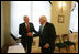 After signing the guest book at the Presidential Palace in Vilnius, Lithuania, Vice President Dick Cheney shakes hands with Lithuanian President Valdus Adamkus, Wednesday May 3, 2006. The two leaders participated in a bilateral meeting to discuss regional issues prior to the beginning of the Vilnius Conference 2006, a summit gathering heads of state from the Baltic and Black Sea regions that begins Thursday.