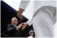Vice President Dick Cheney greets each graduate as they receive their diplomas during the U.S. Naval Academy graduation in Annapolis, Maryland, Friday, May 27, 2005. During the ceremony the Vice President delivered the commencement address to the Class of 2006 and said, "As of today, you, the Custodians of Liberty, will begin writing your own chapter of excellence and achievement for the United States Armed Forces. As military officers you will bring relief to the helpless, hope to the oppressed. You will protect the United States of America in a time of war, and you'll help to build the peace that freedom brings.