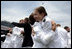 Graduates embrace at the conclusion of the Graduation and Commissioning Ceremony for the U.S. Naval Academy Class of 2006 in Annapolis, Maryland, Friday, May 26, 2006.