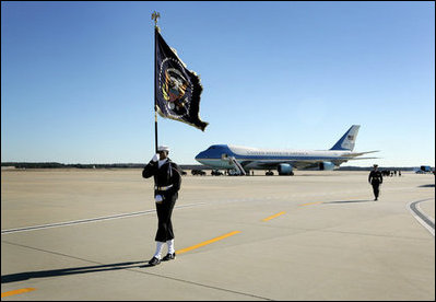 A Naval honor guard carries the Presidential Colors on the tarmac of Andrews Air Force Base, Md., as the plane carrying the body of former President Gerald R. Ford prepares to depart for Grand Rapids, Mich., Tuesday, January 2, 2007, following the former president's State Funeral in Washington, D.C.