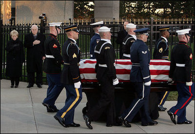 Vice President Dick Cheney and Mrs. Lynne Cheney salute as the casket of former President Gerald R. Ford is carried by a military honor guard during interment ceremonies on the grounds of the Gerald R. Ford Presidential Museum in Grand Rapids, Mich., Wednesday, January 3, 2007.