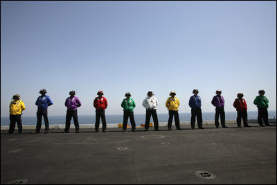  Crew members of the USS John C. Stennis stand on the deck, Friday, May 11, 2007 during Vice President Dick Cheney's arrival to the aircraft carrier. 