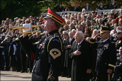 An U.S. Army Band bugler plays Taps during a wreath-laying ceremony at the Tomb of the Unknown Soldier, Sunday, Nov. 11, 2007, at Arlington National Cemetery in Arlington, Va.