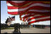 U.S. flags wave in the wind Tuesday, Feb. 26, 2008 during an Uncasing of the Colors Ceremony for the Third Corps at Fort Hood, Texas.