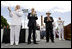 Vice President Dick Cheney is joined by Admiral Thad Allen, Commandant of the U.S. Coast Guard, left, and Secretary Michael Chertoff of Homeland Security, center, in applauding the graduates of the U.S. Coast Guard Academy, Wednesday, May 21, 2008, during commencement exercises in New London, Conn.