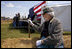 Vice President Dick Cheney delivers remarks during the commemoration of the 145th anniversary of the Battle of Chickamauga in McLemore's Cove, Georgia, as a Confederate re-enactment participant looks on.