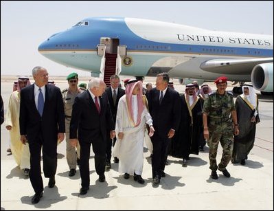Vice President Dick Cheney, former Secretary of State Colin Powell, and former President George H.W. Bush are escorted from the plane by members of the Saudi delegation before meeting with the newly crowned King Abdullah of Saudi Arabia Friday, August 05, 2005. Vice President Dick Cheney led a delegation to pay respects following the recent death of King Fahd.