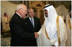Vice President Dick Cheney, left, shake hands with newly crowned King Abdullah, right, during a retreat at King Abdullah's Farm in Riyadh, Saudi Arabia Friday, August 5, 2005, following the death of his half-brother King Fahd who passed away August 1, 2005. Interperter Gamal Helal, center, is also pictured.