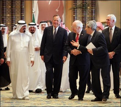 Vice President Dick Cheney and former President George H.W. Bush walks with newly crowned King Abdullah during a retreat at King Abdullah's Farm in Riyadh, Saudi Arabia Friday, August 5, 2005, following the death of his half-brother King Fahd who passed away August 1, 2005. Interpreter Gamal Helal, center, is also pictured.