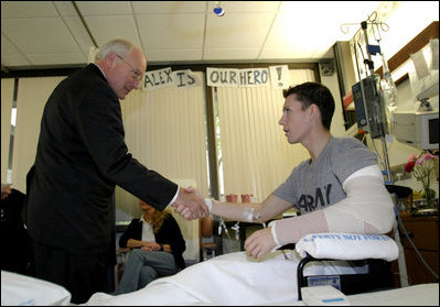 Vice President Dick Cheney greets a wounded soldier at Walter Reed Medical Center in Washington, October 22, 2003. During his visit to Walter Reed the vice president presented soldiers with the Purple Heart, a decoration awarded to any member of the US Armed Services wounded in combat.