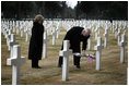 Vice President Dick Cheney places a rose on the grave of Wyoming soldier Sgt. John Vannoy while touring the Sicily-Rome American Cemetery with his wife, Lynne, in Nettuno, Italy January 26, 2004. The cemetery inters those who gave their life for the liberation of Italy during World War II.