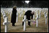 Vice President Dick Cheney places a rose on the grave of Wyoming soldier Sgt. John Vannoy while touring the Sicily-Rome American Cemetery with his wife, Lynne, in Nettuno, Italy January 26, 2004. The cemetery inters those who gave their life for the liberation of Italy during World War II.