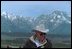 Framed by the snow-capped peaks of the Grand Teton Mountain Range, Vice President Cheney tours the countryside on horseback with his family, who are not pictured.