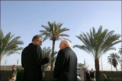 Vice President Dick Cheney speaks with Zalmay Khalilzad, US Ambassador to Iraq, inside the Green Zone, Sunday Dec. 18, 2005.