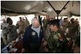 Vice President Dick Cheney has lunch with US and Iraqi troops at the 9th Mechanized Infantry Division Headquarters, a training facility for Iraqi troops, Sunday Dec 18, 2005.