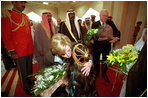 Two children greet Vice Present Dick Cheney and Mrs. Cheney with bouquets of flowers upon their arrival at Dasman Palace in Kuwait City, Kuwait, March 18.
