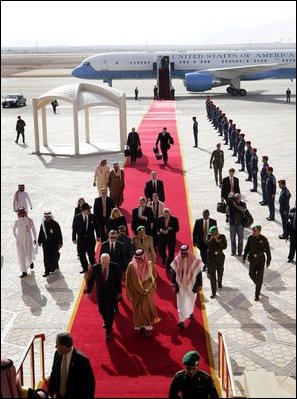Followed by a group of Saudi and US delegates, Vice President Dick Cheney walks down a red carpet with Prince Saud al-Faisal bin Abdulaziz, Saudi Minister of Foreign Affairs, upon arrival to King Khalid International Airport in Saudi Arabia, Tuesday January 17, 2006.