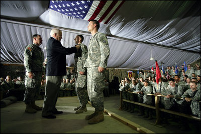 Vice President Dick Cheney awards Staff Sergeant Vincent Lewis with the Combat Infantry Badge during a rally for the troops Thursday, May 10, 2007 at Contingency Operating Base Speicher, Iraq.