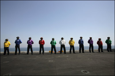 Crew members of the USS John C. Stennis stand on deck Friday, May 11, 2007 during Vice President Dick Cheney's arrival to the aircraft carrier. While aboard the Nimiz-class vessel the Vice President participated in a classified briefing and rally for the troops.