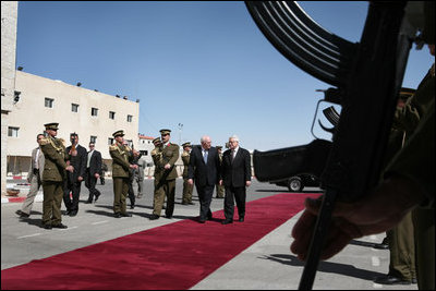 Vice President Dick Cheney and President Mahmoud Abbas of the Palestinian Authority walk through an honor cordon after the arrival Sunday, March 23, 2008, of the vice president to the West Bank city of Ramallah.