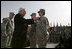 Vice President Dick Cheney awards PFC Veronica Alfaro with the Bronze Star Tuesday, March 18, 2008, during a rally for U.S. troops at Balad Air Base, Iraq. "I can't describe the feeling I had when he awarded me the Bronze Star," said Alfaro, 2nd Platoon senior medic, Bravo Company. "It is definitely a moment I will always remember and cherish; I will never forget it."