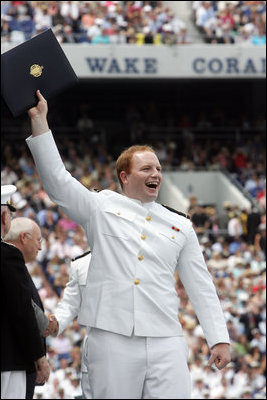 A graduate celebrates after receiving his diploma from Vice President Dick Cheney during the Graduation and Commissioning Ceremony for the U.S. Naval Academy Class of 2006, Friday, May 26, 2006 in Annapolis, Maryland.