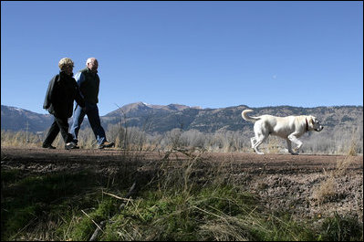 Vice President Dick Cheney and his wife Lynne walk along the banks of the Snake River with their dog "Dave."