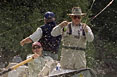 Vice President Dick Cheney reels in a trout from the bow of a fishing boat on the Snake River in Idaho.