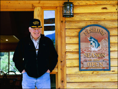 Vice President Dick Cheney stands outside a cabin on the banks of the Snake River during a fishing trip to Idaho.