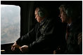 Vice President Dick Cheney and US Ambassador to Pakistan Ryan Crocker survey the devastation of Pakistan's earthquake zone Tuesday, December 20, 2005. At the peak of initial relief efforts, the U.S. had more than 1,200 personnel and 24 helicopters in the affected areas. American troops have flown more than 2,600 helicopter flights to deliver nearly 12 million pounds of relief supplies while US personnel have cared for more than 11,000 Pakistanis and supplied critical engineering support.