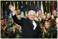 Vice President Dick Cheney waves in response to a warm welcome given by the troops and their families at a rally at Scott Air Base in Illinois, Tuesday, March 21, 2006.