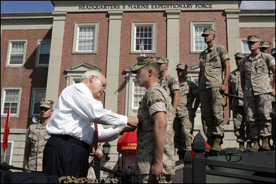 Vice President Dick Cheney pins the Purple Heart Medal onto U.S. Marine CPL Daniel Foot during a rally at Camp Lejeune in Jacksonville, NC, Monday October 3, 2005. The Vice President awarded five soldiers with medal at that time, honoring their valor in the field of battle.