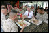 Vice President Dick Cheney talks with Marines over lunch at Camp Lejeune in Jacksonville, NC, Monday October 3, 2005.