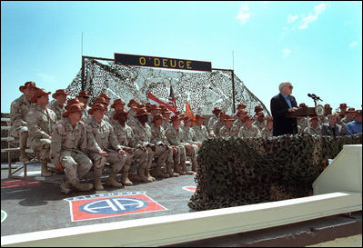 Vice President Dick Cheney addresses troops from the Arkansas National Guard in Sharm El-Sheikh, Egypt, March 13, 2002. "You, and everyone around you, are doing your duty and reflecting credit on yourselves, your families, and your country," said the vice president during a speech at the airbase. "You're here because you believe in America, and America believes in you."
