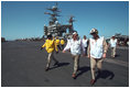 Vice President Dick Cheney walks the deck of the USS Stennis Aircraft Carrier, deployed in the Indian Ocean, March 15, 2002.