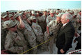 Troops at Al-Udeid Airbase in Qatar gather around Vice President Dick Cheney for pictures and handshakes March 17, 2002.
