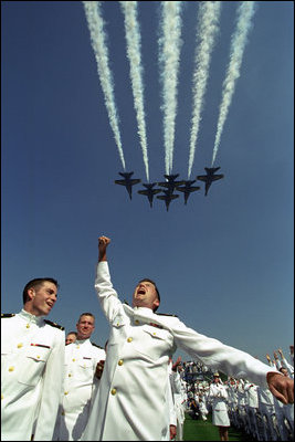 A graduate of the Naval Academy class of 2002 pumps his fist in celebration as the Blue Angels flyover in formation marking the conclusion of the US Naval Academy graduation in Annapolis, Maryland, May 24, 2002.