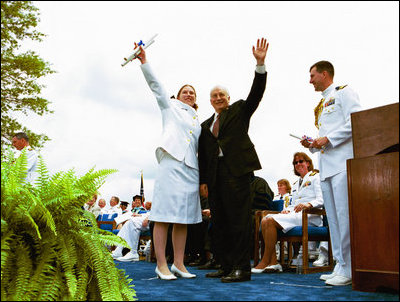 Following his commencement address to the U.S. Coast Guard Academy, Vice President Dick Cheney and Cadet Jen Frye, 22, of New Market, VA, wave to her friends and family after he presented the graduating cadet her commission in New London, Conn., Wednesday, May 19, 2004.