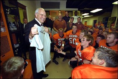 Moments before the dedication ceremony of the Cheney Alumni Field, Vice President Dick Cheney talks with the Natrona County High School football team in the locker room in Casper, Wyo., Sept. 20, 2002. 