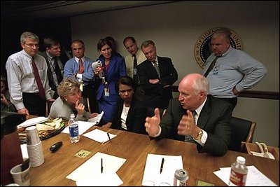 Immediately after the Sept. 11 terrorist attacks, Vice President Dick Cheney and senior staff gathered in the Presidential Emergency Operations Center. White House staff collected and discussed information as the day unfolded, and they kept in contact with the President. Photographed are Counselor Karen Hughes (seated left), National Security Advisor Dr. Condoleezza Rice (seated right), Deputy Chief of Staff Josh Bolten (far left), Director of Media Affairs Tucker Eskew, Assistant to the President Nick Calio, Counselor to the Vice President Mary Matalin, Chief of Staff for the Vice President Lewis Libby, and Director of the National Economic Council Larry Lindsey (right).