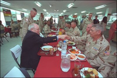 Stationed in Egypt, American troops are participating in an 11-country international peacekeeping force called the Multinational Force of Observers. Here, they share conversation and lunch with Vice President Dick Cheney during his visit to the base March 13, 2002. The MFO is an international peacekeeping force established by Egypt and Israel to monitor the security arrangements of their Treaty of Peace.