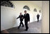 President George W. Bush walks with Prime Minister John Howard of Australia along the colonnade in the Rose Garden Tuesday, May 16, 2006.
