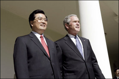 President George W. Bush and Chinese President Hu look out over the Rose Garden after meeting in the Oval Office Thursday, April 20, 2006.