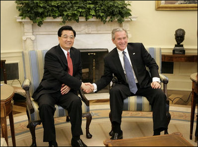President George W. Bush hosts a visit by Chinese President Hu Jintao to the Oval Office Thursday, April 20, 2006.