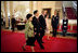Madam Liu Yongqing, Chinese President Hu Jintao, President George W. Bush and Mrs. Laura Bush walk in the Cross Hall to the luncheon in the East Room Thursday, April 20, 2006.