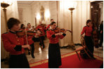 Roving musicians enter the State Dining Room, Monday, July 18, 2005 at the White House, at the official dinner in honor of the visit by India's Prime Minister Dr. Manmohan Singh. White House photo by Eric Draper