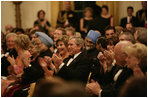 President George W. Bush, Laura Bush and India Prime Minister Dr. Manmohan Singh and Mrs. Gursharan Kaur, applaud the entertainers appearing Monday, July 18, 2005 at the official dinner at the White House. White House photo by Eric Draper
